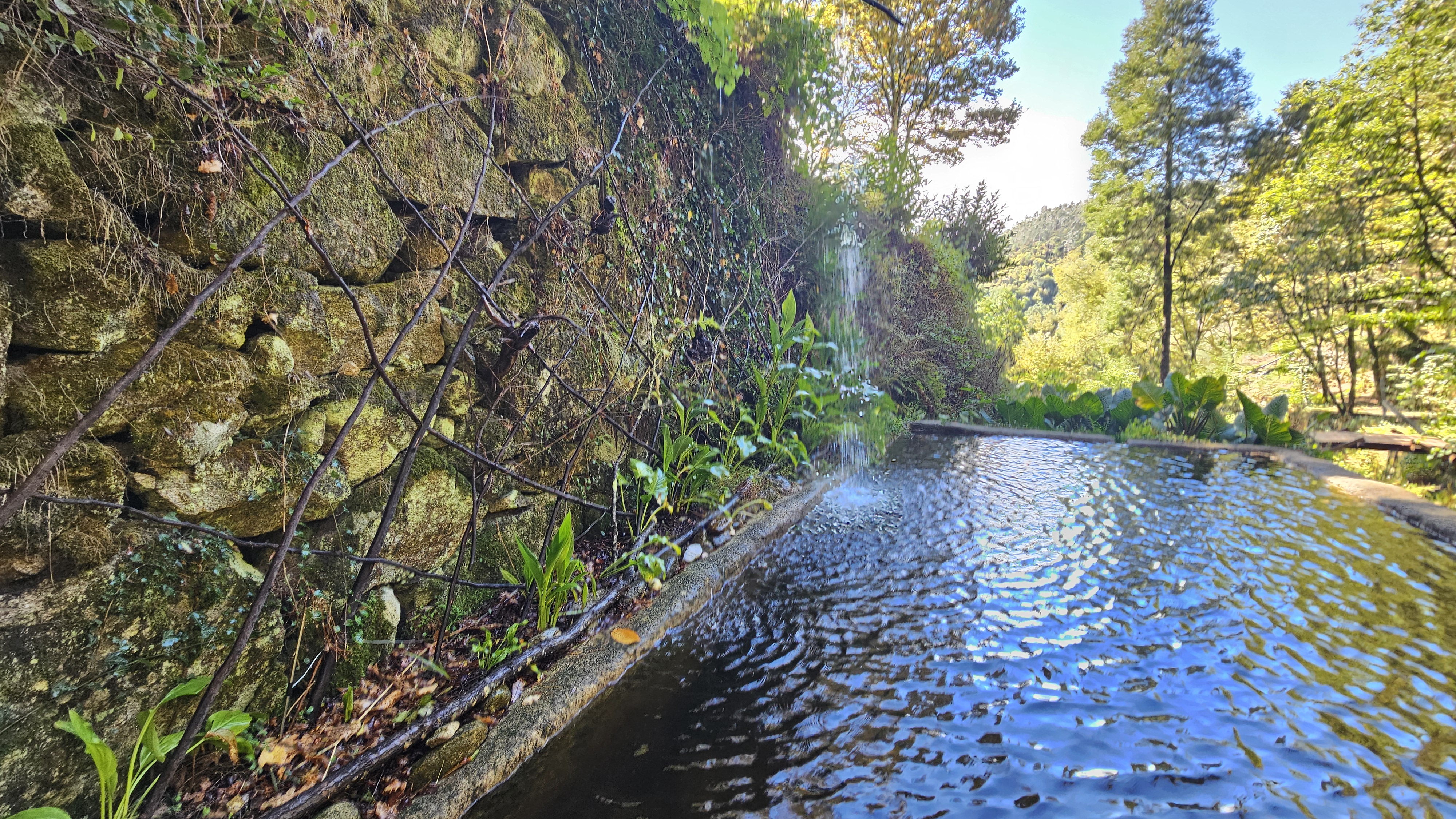 Stone wall alongside traditional water channel